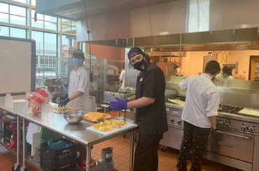 Culinary students cooking up creations for the Nacho Master Competition.