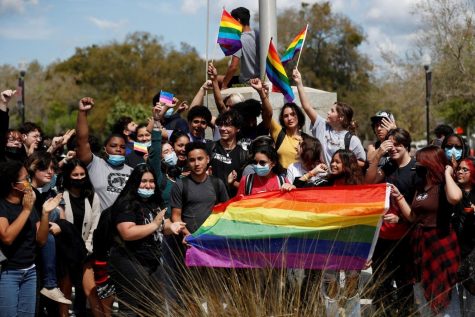 In the image above, students of a Tampa Bay school are waving pride flags during a walk-out protest. 