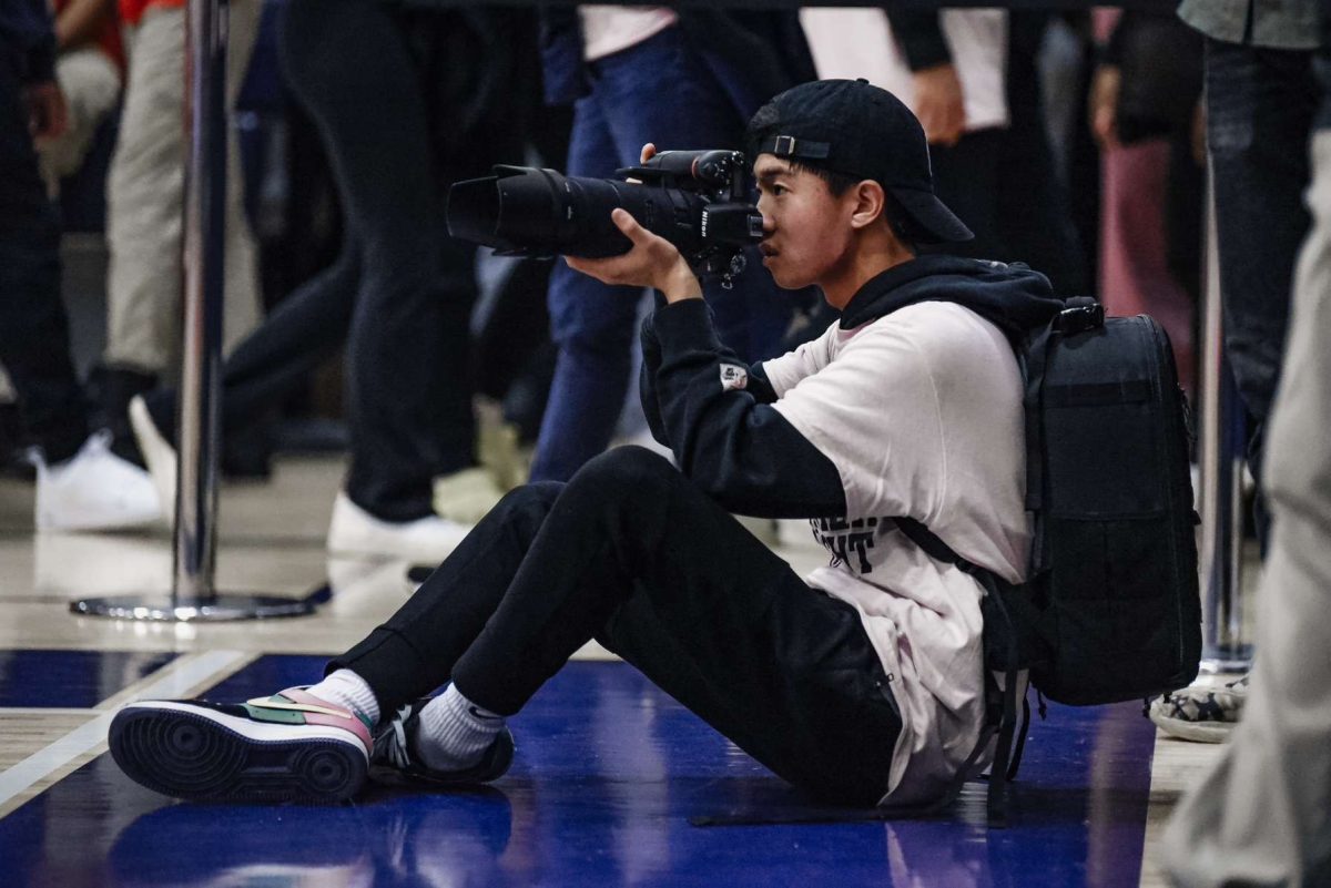 Matthew Barber (25), the man behind Shotsby_mattb, takes pictures from the sidelines of a Patriot basketball game.
