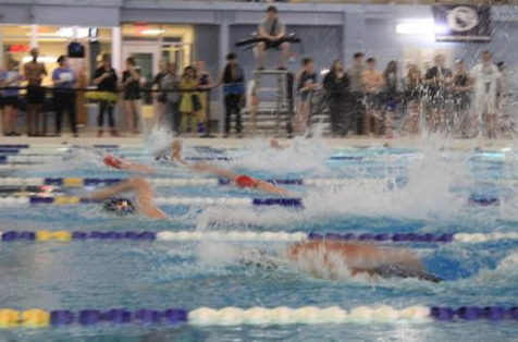 This photo was taken on January 26, 2024, at the Prince William Aquatic Center during the Girls and Boys Varsity Swim and Dive. The Varsity Swim and Dive consisted of Patriot Highschool swimmers as well as other swimmers from other high schools. On the sidelines were staff, coaches, and supporters of their teams.