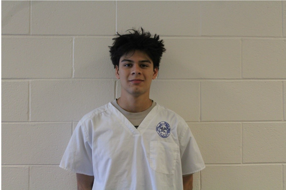 Valentino Lukis posing with his nursing scrubs. 