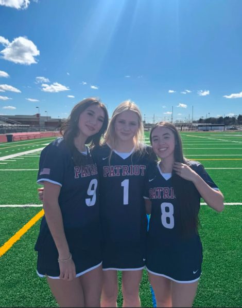 Caption: Junior Standouts Olivia Ozark, Faith Fernandez, and Karson Ophof pose together at picture day. 
