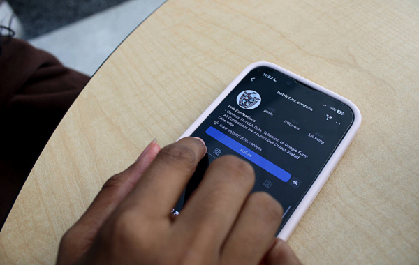 A Patriot High School student scrolls through her school’s Instagram confessions page. Photo taken by Sarah Rashid.