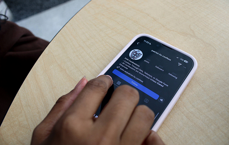 A Patriot High School student scrolls through her school’s Instagram confessions page. Photo taken by Sarah Rashid.