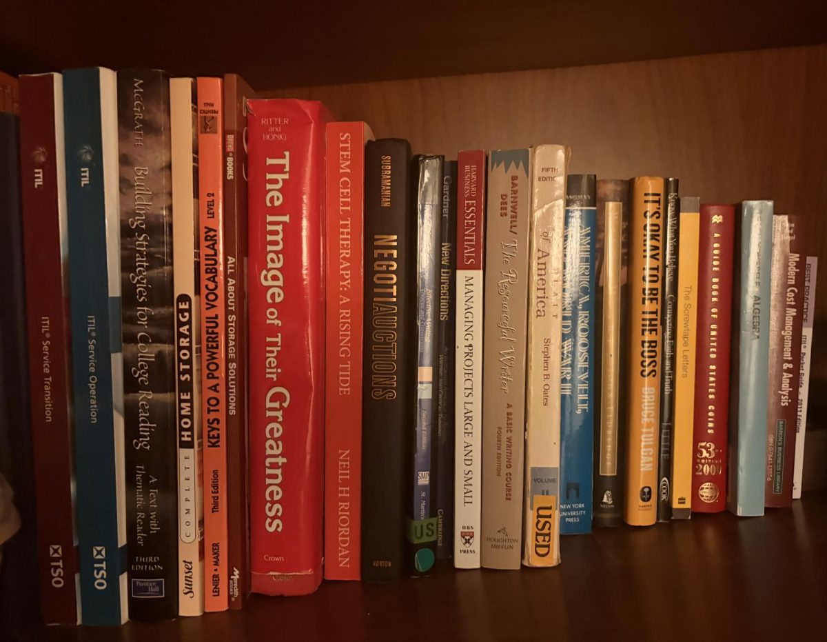 A bookshelf containing various book titles. Reading books is one of the key aspects of developing literacy.